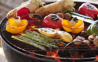 Various grilled vegetables on a barbecue.