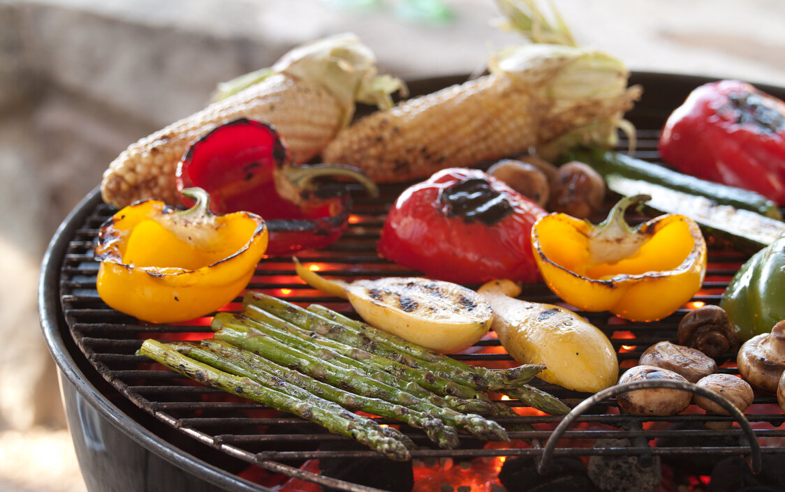 Various grilled vegetables on a barbecue.