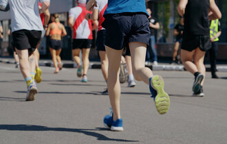 Feet,Of,Athletes,Running,Marathon,In,City,,Onlookers,On,Roadside.