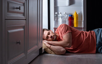 Exhausted,Man,Sleeping,Near,Open,Refrigerator,On,Kitchen,Floor