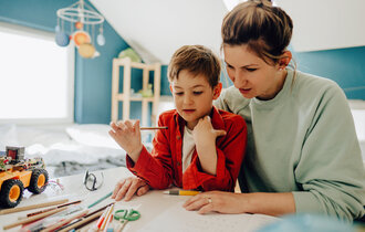 A young boy being homeschooled