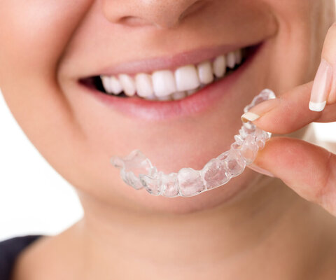 Woman,With,Perfect,Teeth,Holding,Invisible,Braces,,Correction,Teeth,Braces