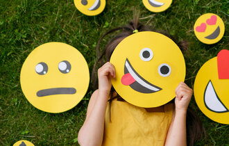 The,Child,Covers,His,Face,With,A,Emoticon,Showing,His
