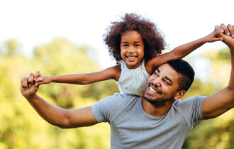 Portrait,Of,Young,Father,Carrying,His,Daughter,On,His,Back