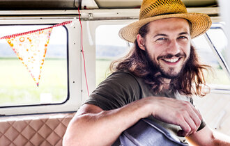 Portrait of happy young man inside a van