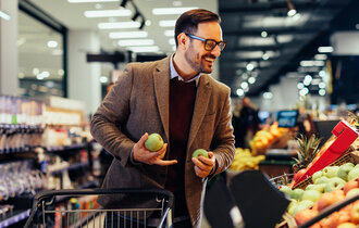 A,Young,Man,Looking,At,Fresh,Fruits,In,The,Supermarket,