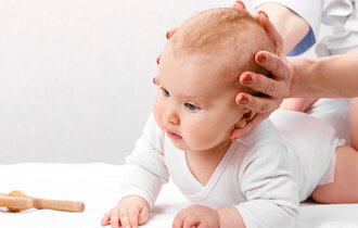 Six,Month,Baby,Girl,Receiving,Osteopathic,Or,Chiropractic,Treatment,In